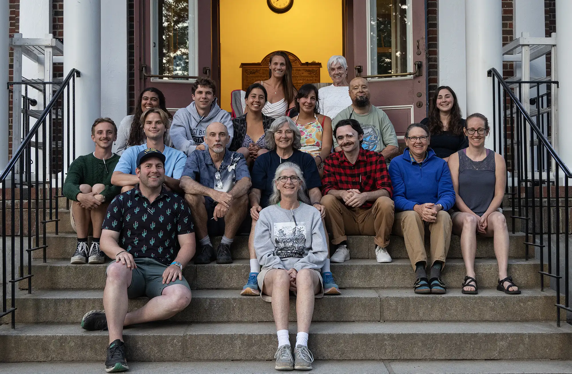 staff-photo-2025 Staff members sitting on steps